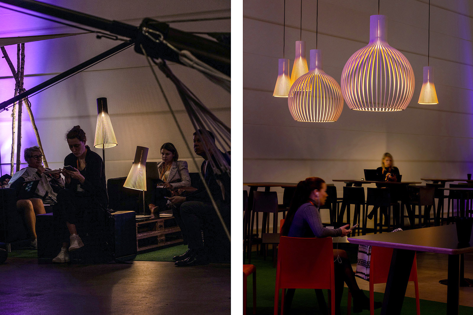 A floor lamp and a table lamp illuminating people discussing. Two women sitting by desks under wooden pendants. 