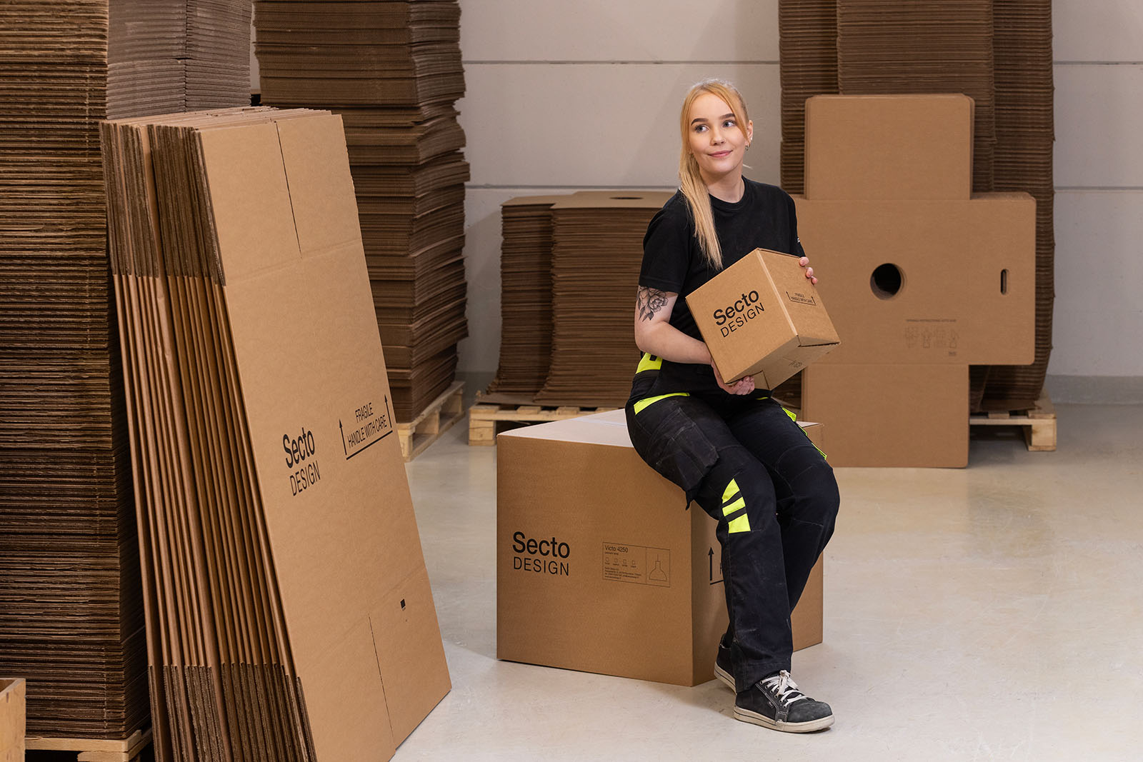 A woman sitting on a cardboard box.